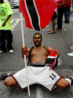 Masquerader with TnT flag at Downtown Parade