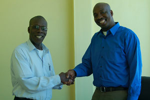 DR MORGAN JOB, shaking hands with SOCA 91.9FM CEO NEIL ‘IWER’ GEORGE